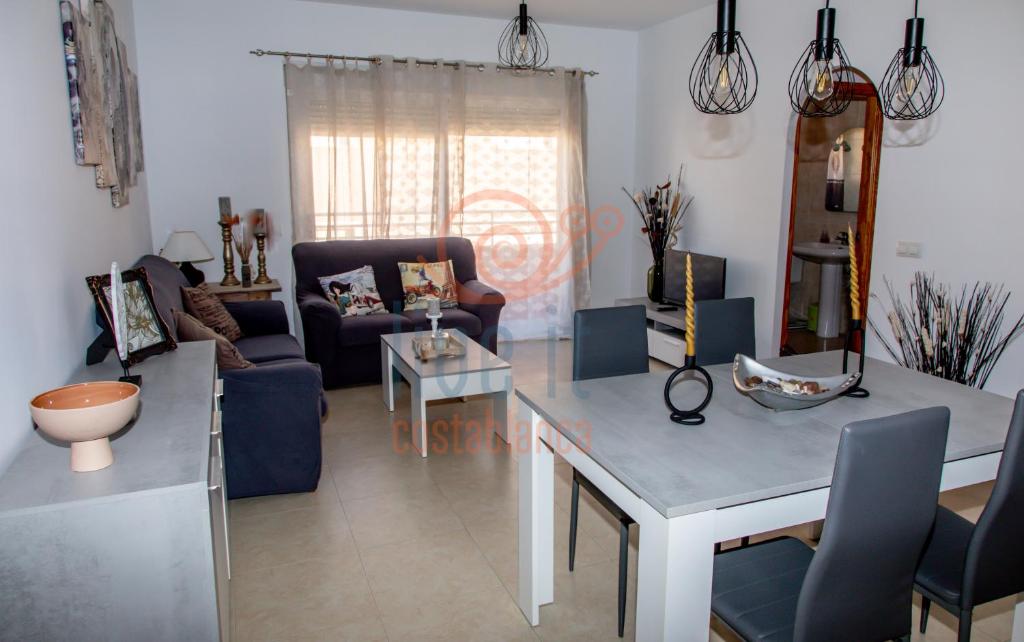 a living room with a table and a mirror at APARTAMENTO ZEN. TEULADA. LIVE IT COSTABLANCA in Teulada