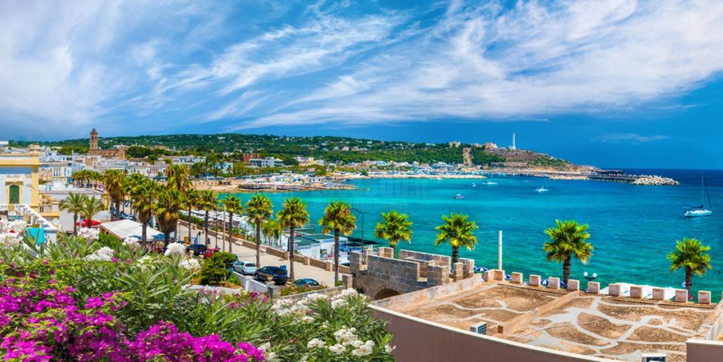 a view of a harbor with palm trees and the ocean at Leuca lungomare by LoveSud in Leuca