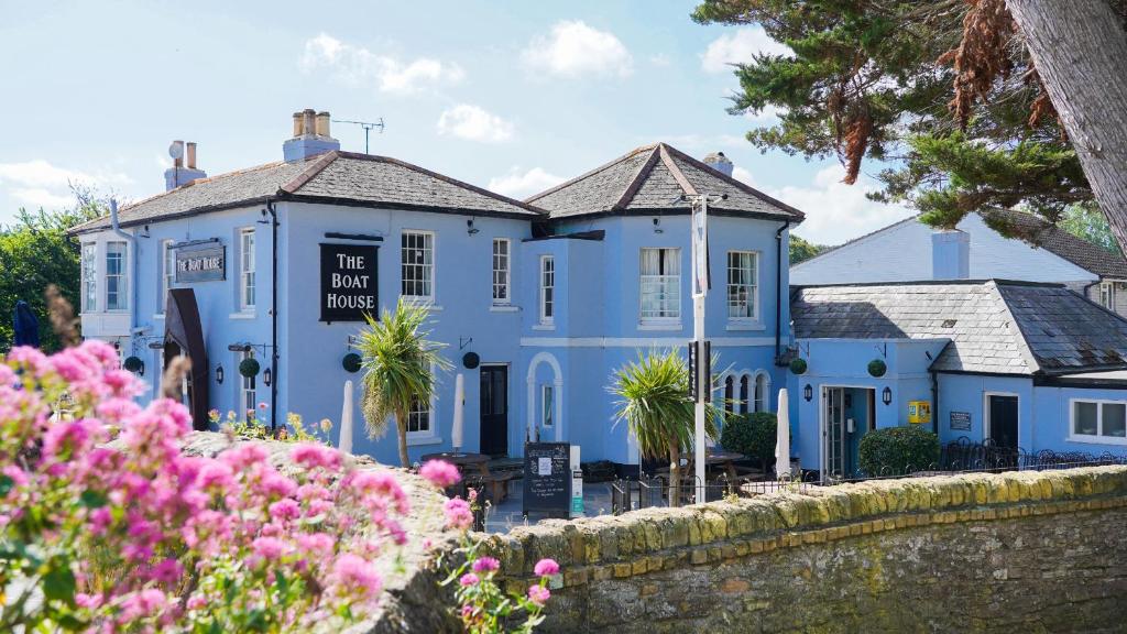 a blue house with flowers in front of it at The Boathouse in Seaview