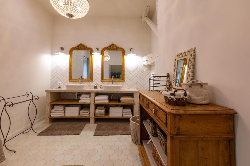 a bathroom with a sink and two mirrors at Mas des Coteaux - vue panoramique - piscine - babyfoot - pingpong - pétanque &amp; espace enfants à 1h de MONTAUBAN in Gramont