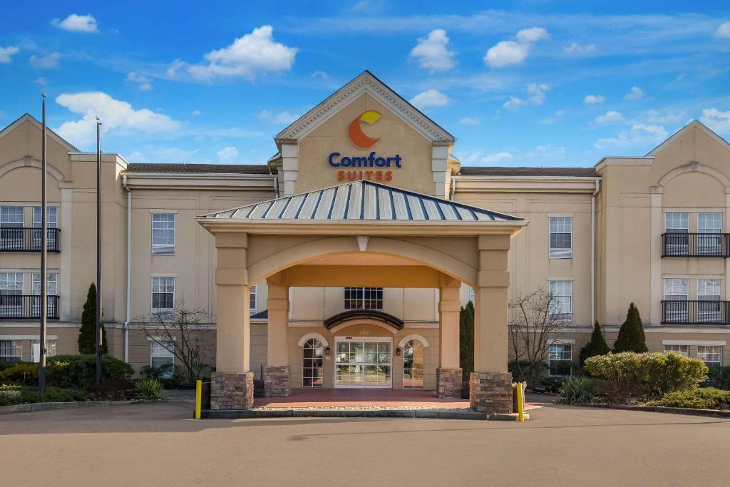 a building with a sign on the front of it at Comfort Suites Near University in North Brunswick