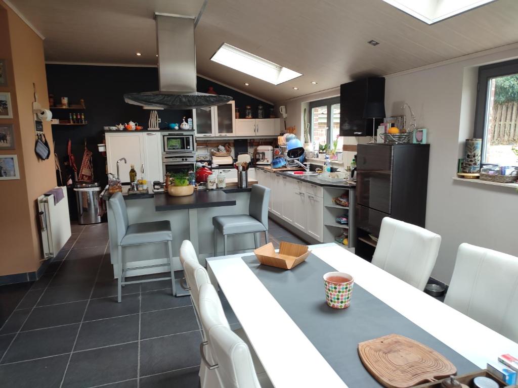 a kitchen with a table and chairs and a kitchen with a counter at L 'Anima BB & table d'hôte in Helecine