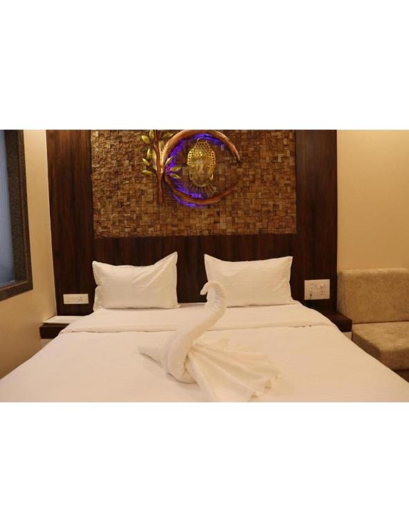 - une chambre avec 2 lits et une horloge murale dans l'établissement Hotel President, Jodhpur, à Jodhpur