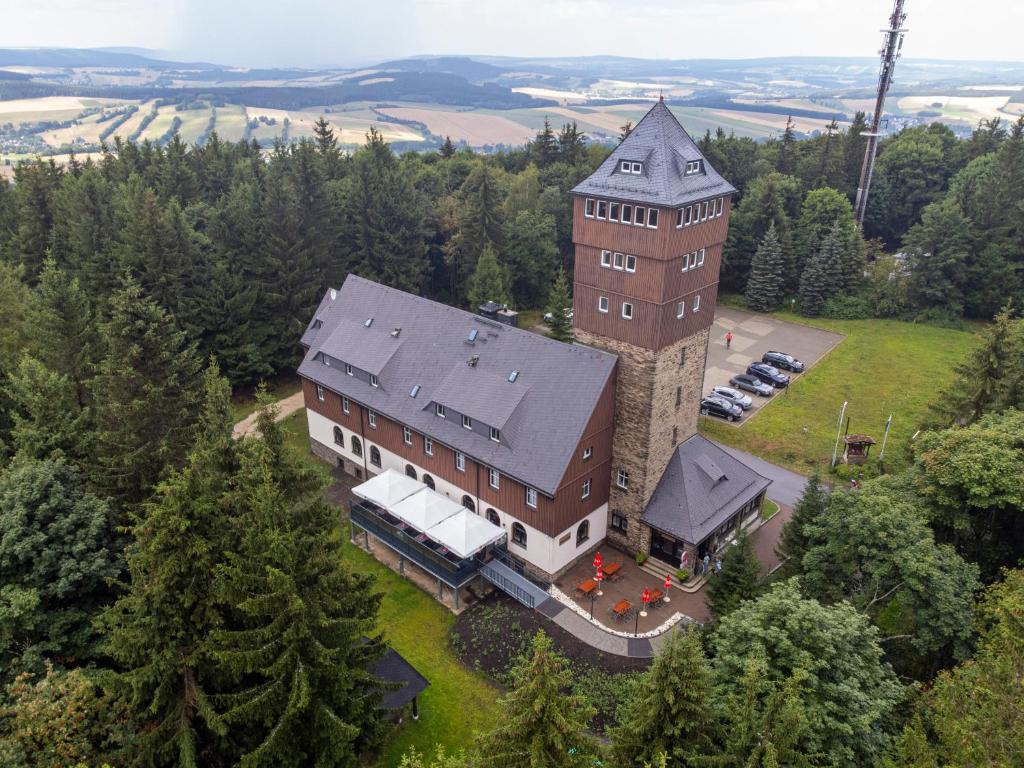 an aerial view of a large building with a tower at Berghotel Bärenstein in Bärenstein