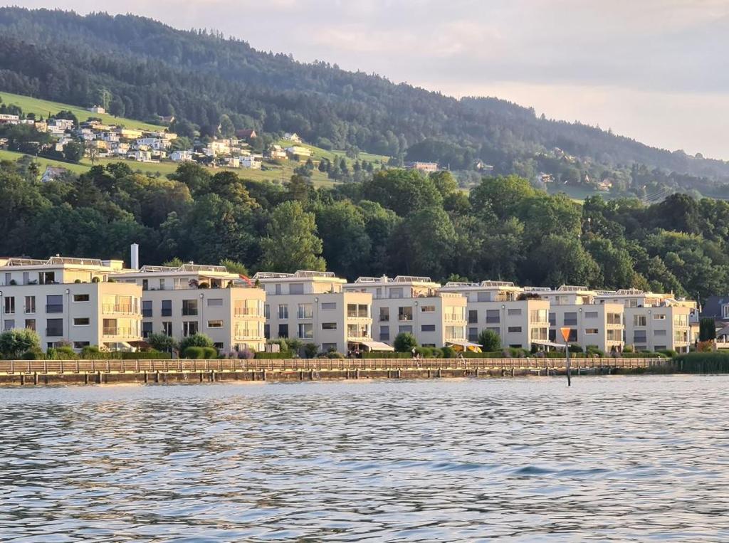 a group of buildings on the shore of a body of water at SEASIDE Appartement in Staad