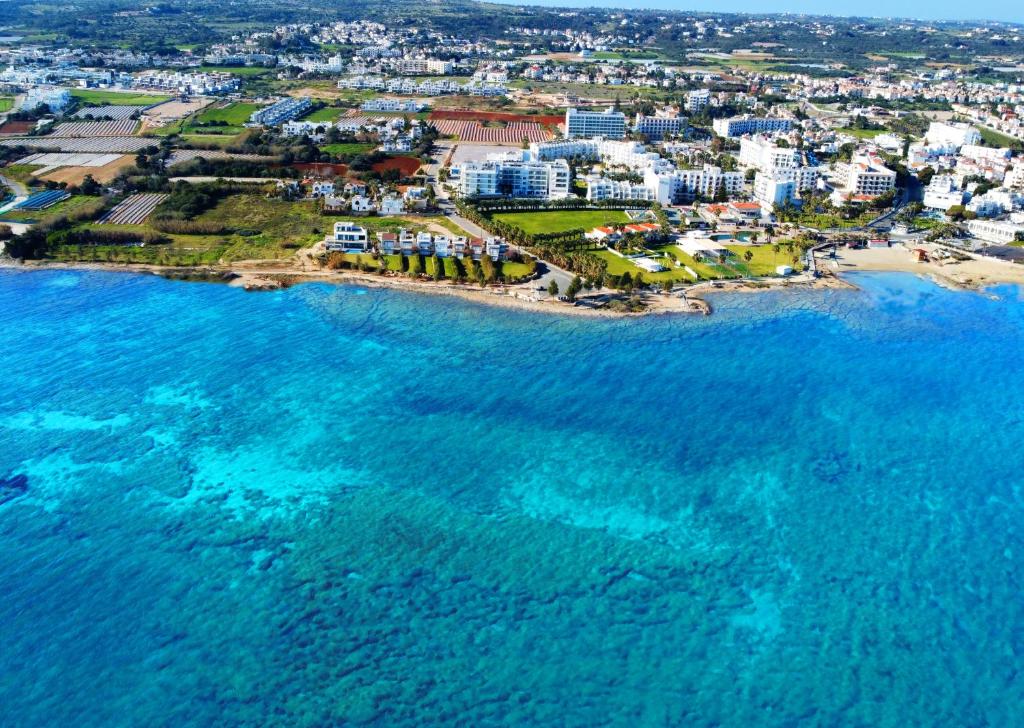 an aerial view of a beach with buildings and the ocean at At Herbal Boutique Hotel & Spa in Protaras