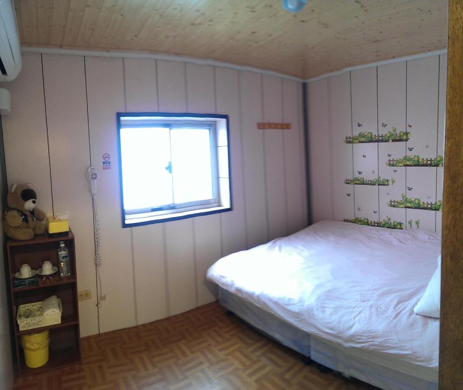 Postel nebo postele na pokoji v ubytování Linyuan Village