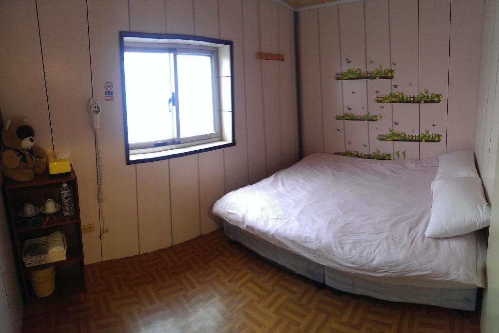 Postel nebo postele na pokoji v ubytování Linyuan Village
