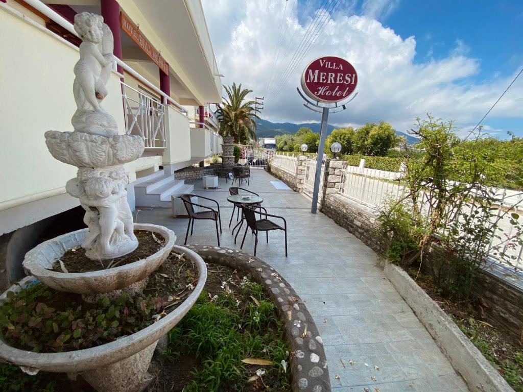 a patio with a fountain outside of a restaurant at Villa Meresi - Thassos Town Center in Limenas