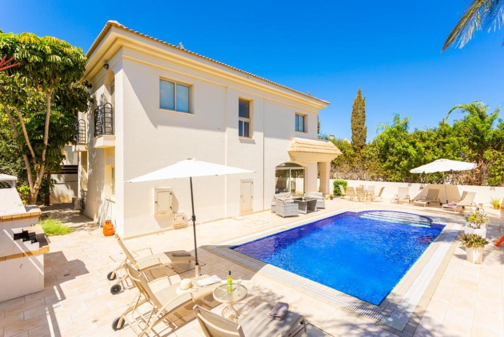 a villa with a swimming pool and a house at Villa Andree in Paralimni