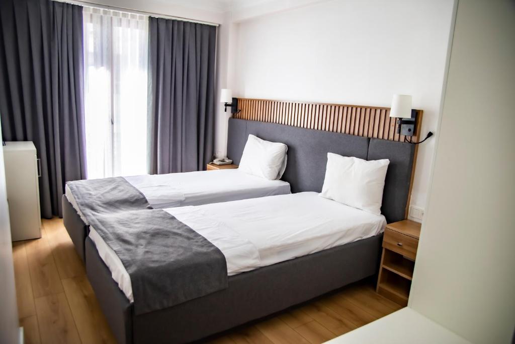 A bed or beds in a room at Silvana Hotel