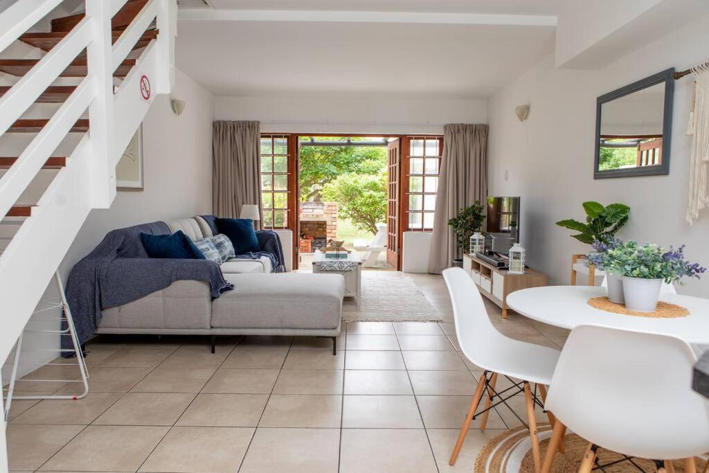 a living room with a couch and a table at Beachfront Accommodation in Port Alfred