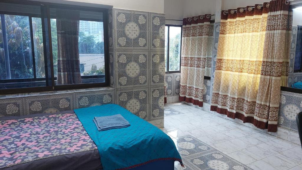 a bedroom with a bed and two windows at Homestay 2 in Dhaka