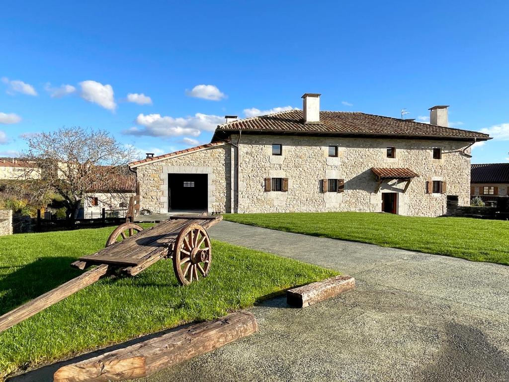 a stone building with a bench in front of it at CASA RURAL ERVITENA in Oteiza