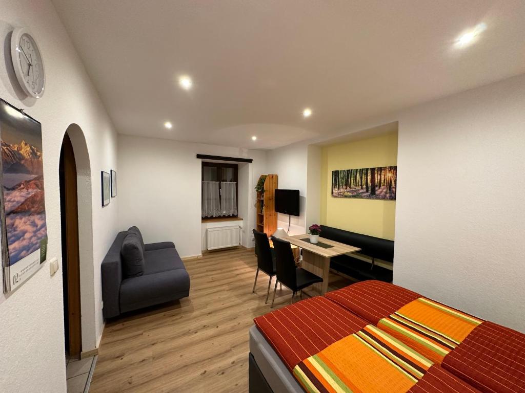 a bedroom with a bed and a desk with a chair at Ferienwohnung Wohlfahrter in Bad Mitterndorf