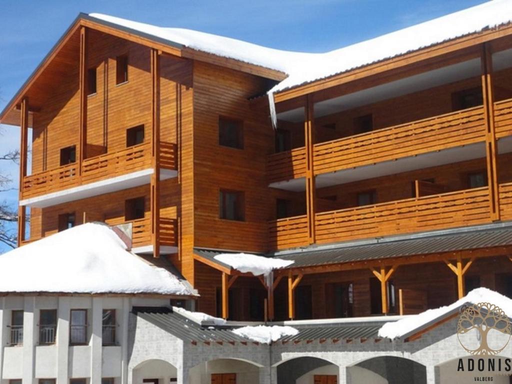 a building covered in snow with snow covered roofs at Adonis Valberg in Valberg