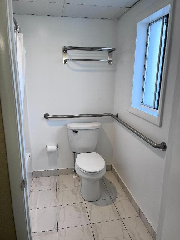 a bathroom with a toilet and a window at Sahara Motel in Ocean City