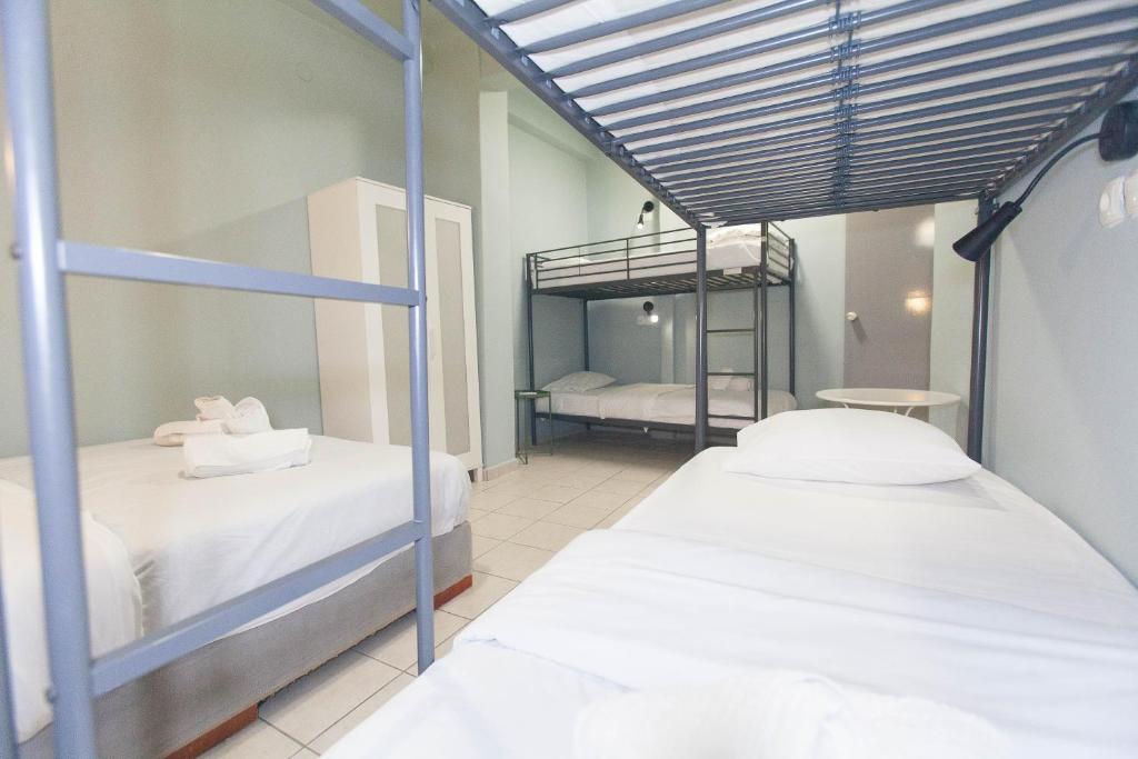 two beds in a room with two bunk beds at Athens City Themis 5 in Athens