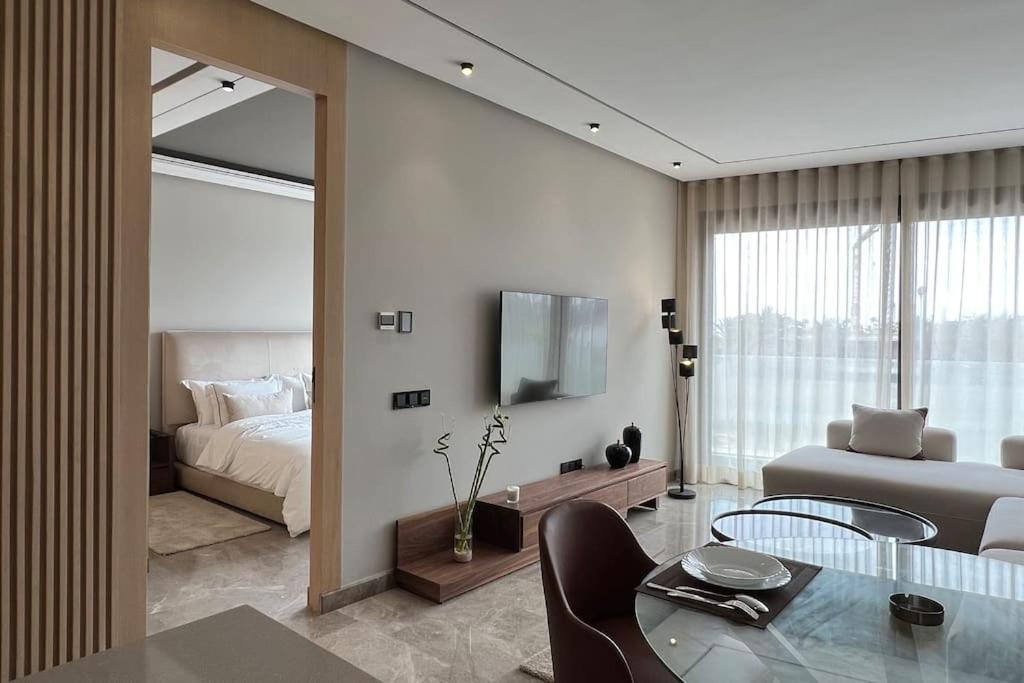 a living room with a bed and a table and a bedroom at Royal Suite by the Ocean - By Appartali in Casablanca