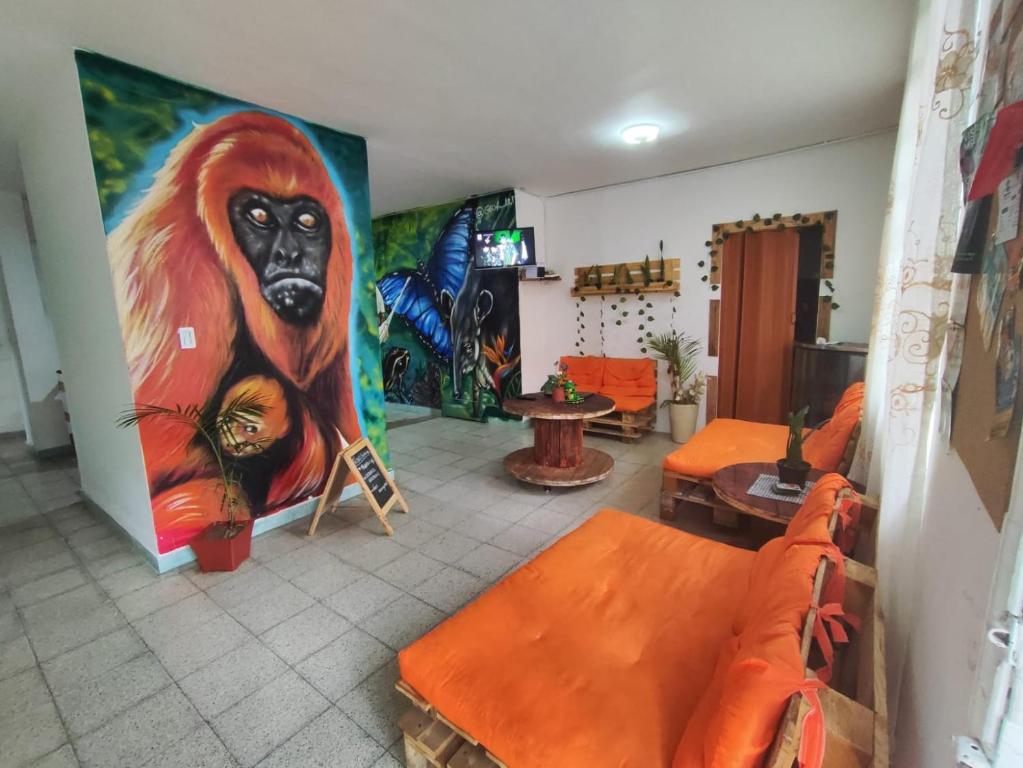 a room with a large painting of a monkey on the wall at Serrania Hostal in Medellín