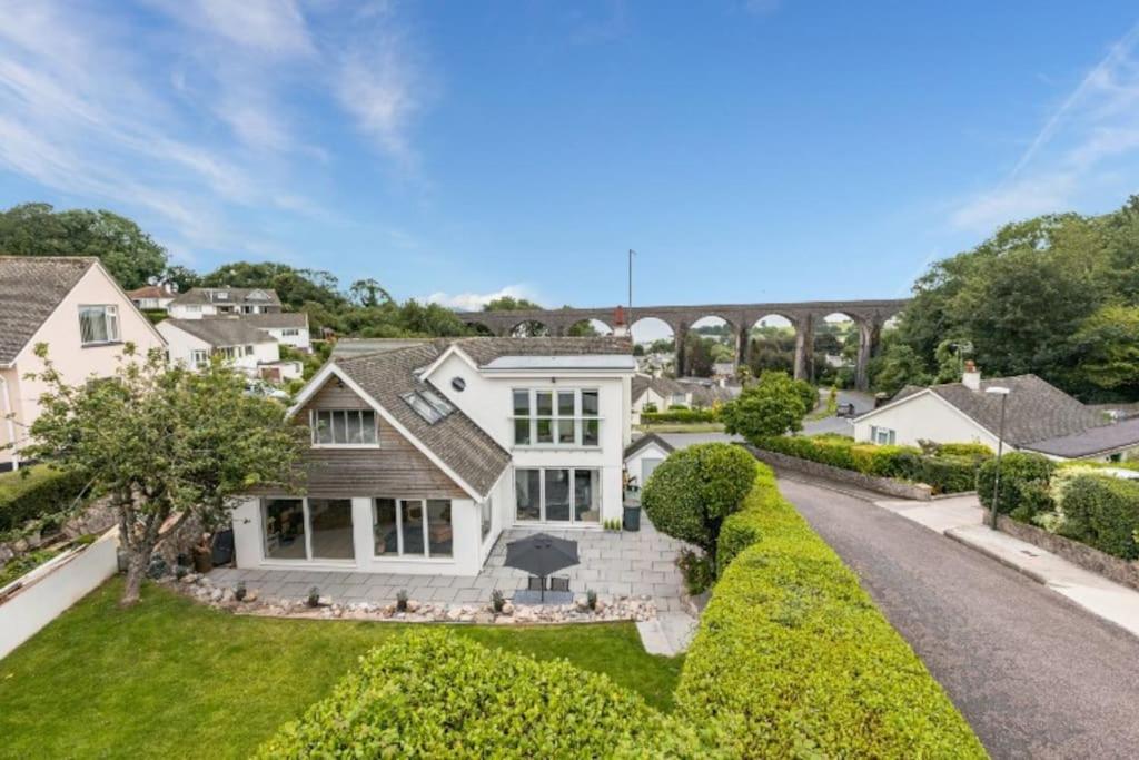 an exterior view of a white house at Beautifully presented holiday home near the beach in Churston Ferrers