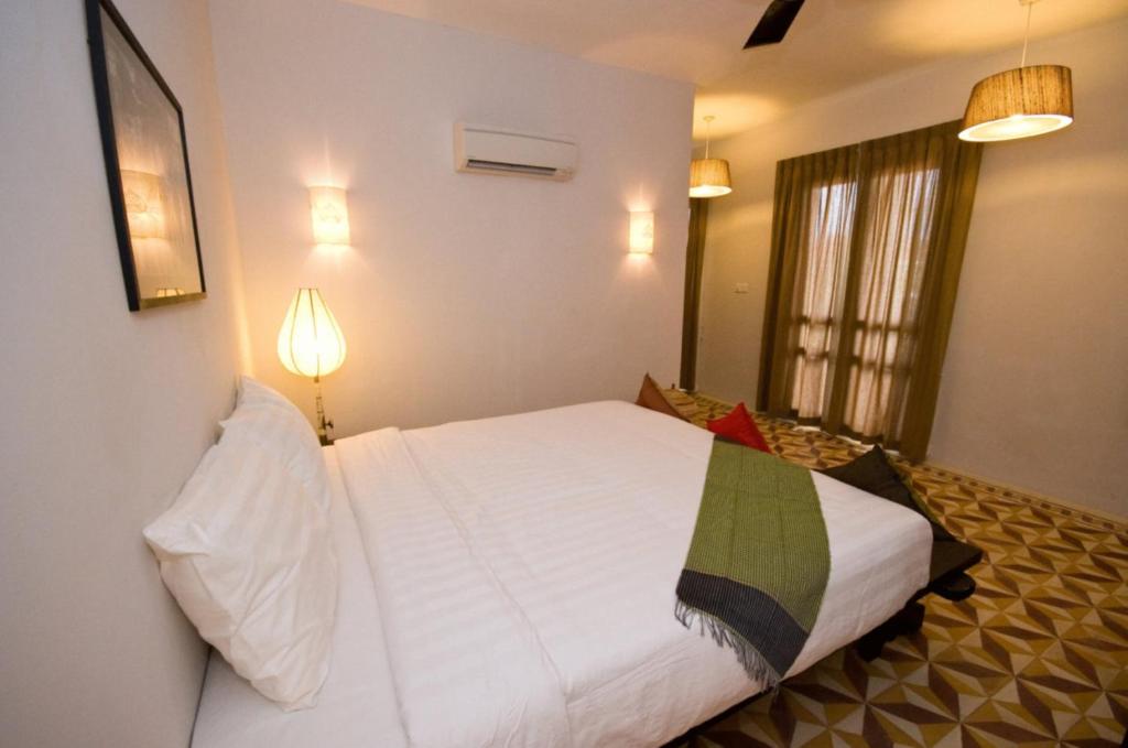 Postel nebo postele na pokoji v ubytování Bambu Hotel