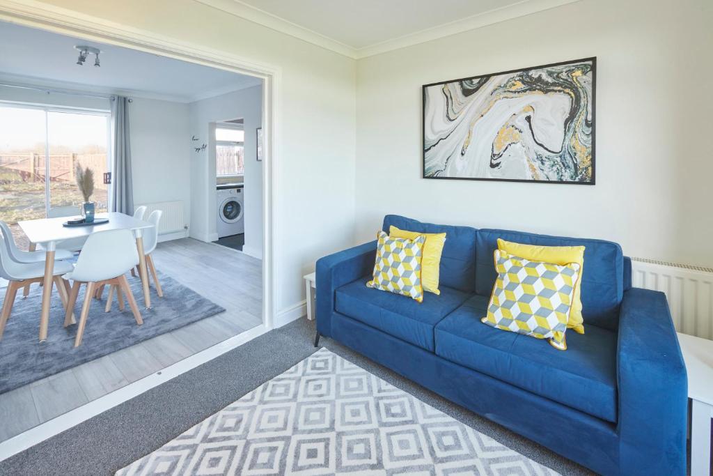 a living room with a blue couch and a table at Host & Stay - Armitage Road in Redcar