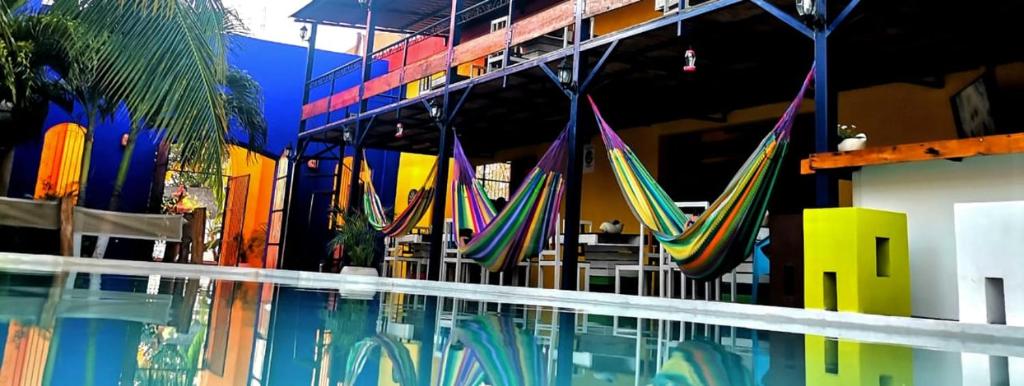 a pool with chairs and umbrellas in a building at Hotel Chuburna in Chuburná