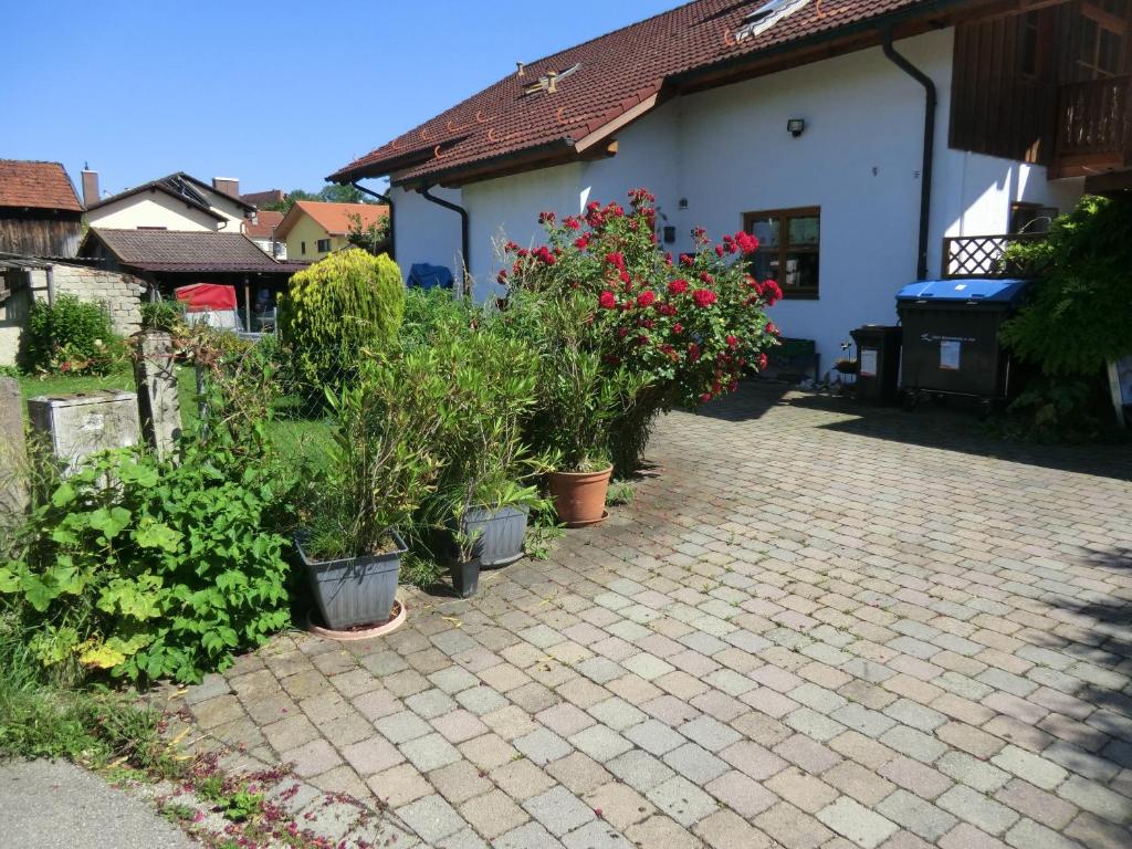 a brick driveway with potted plants in front of a house at Urlaub am Inn in Wasserburg am Inn