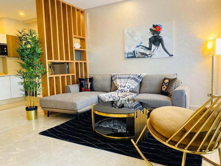 a living room with a couch and a table at Mogador Presidential Terrace - By AppartAli in Casablanca