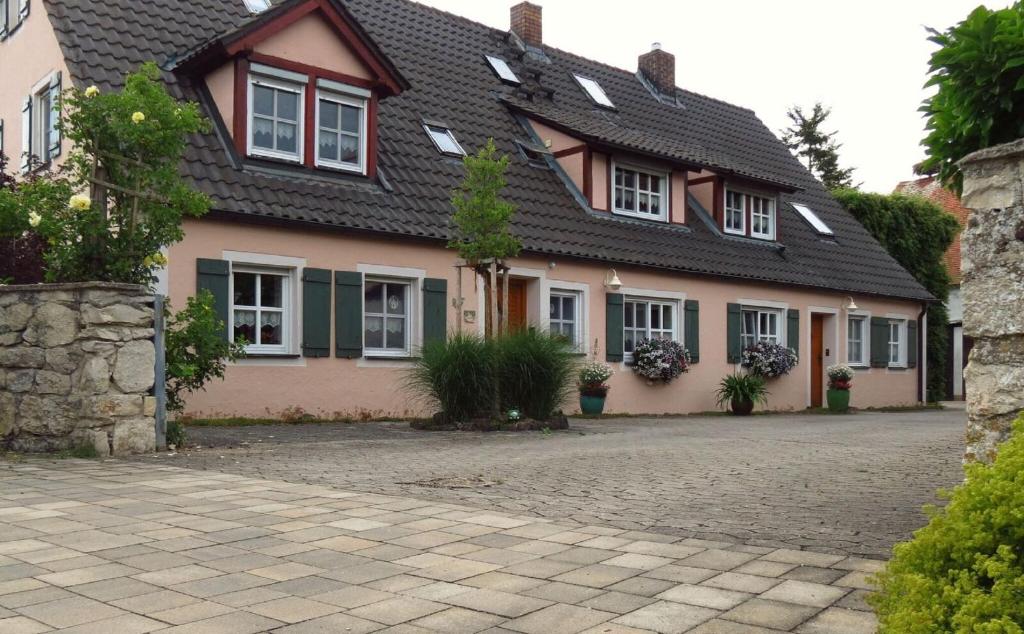 a house with a brick driveway in front of it at Ferienwohnung Schindler mit Balkon in Merkendorf