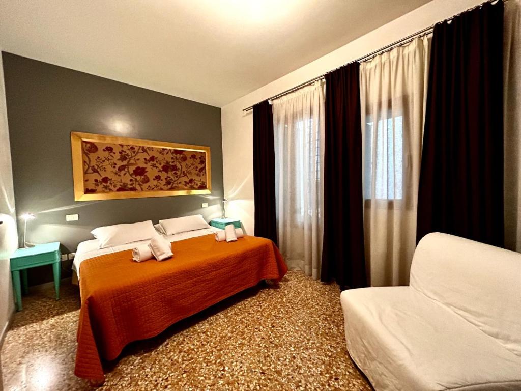 a bedroom with a bed with two stuffed animals on it at Grimaldi Apartments Cannaregio in Venice