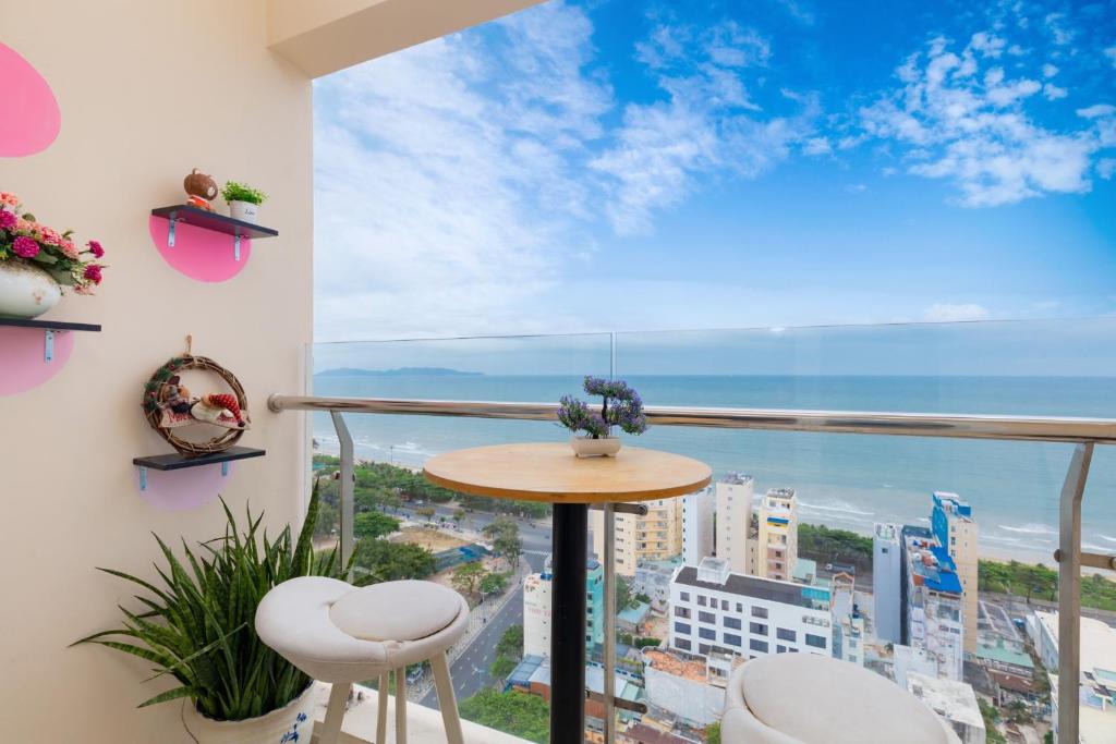 a balcony with a table and chairs and a view of the ocean at Nice Apartment Oasky Vũng Tàu 1805 in Vung Tau