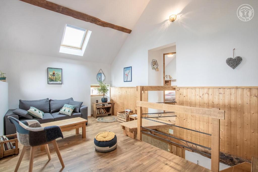 a living room with a couch and a table at Gite la Montagnette in Ruffieux