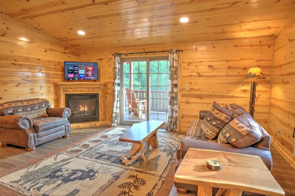 a living room with a couch and a fireplace at Blessing Lodge by Amish Country Lodging in Berlin