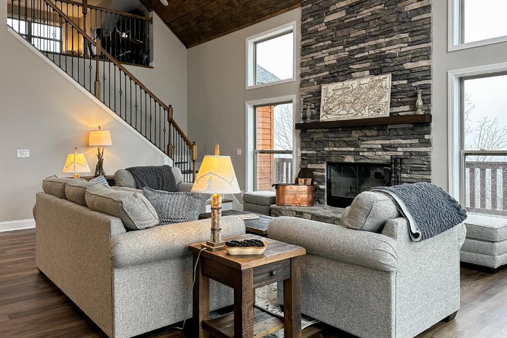 a living room with two couches and a fireplace at Shady Pines in Gatlinburg