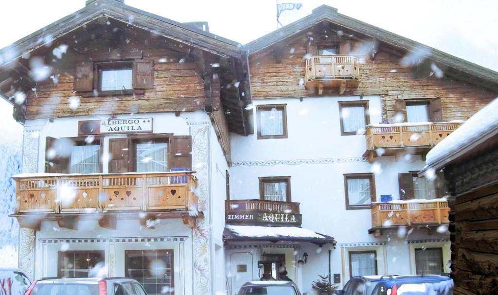 a large building with balconies on the side of it at Hotel Aquila in Livigno