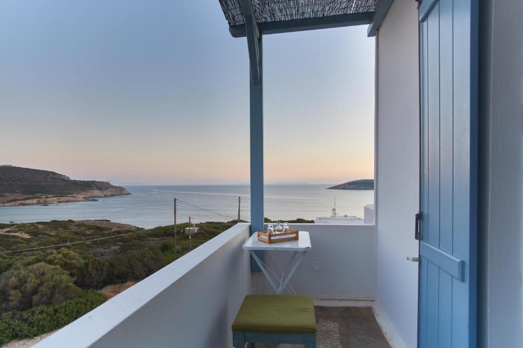 a balcony with a view of the ocean at Oliaros seaside complex in Agios Georgios