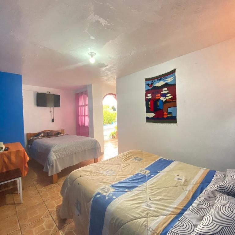 Postel nebo postele na pokoji v ubytování Hostal Chasqui