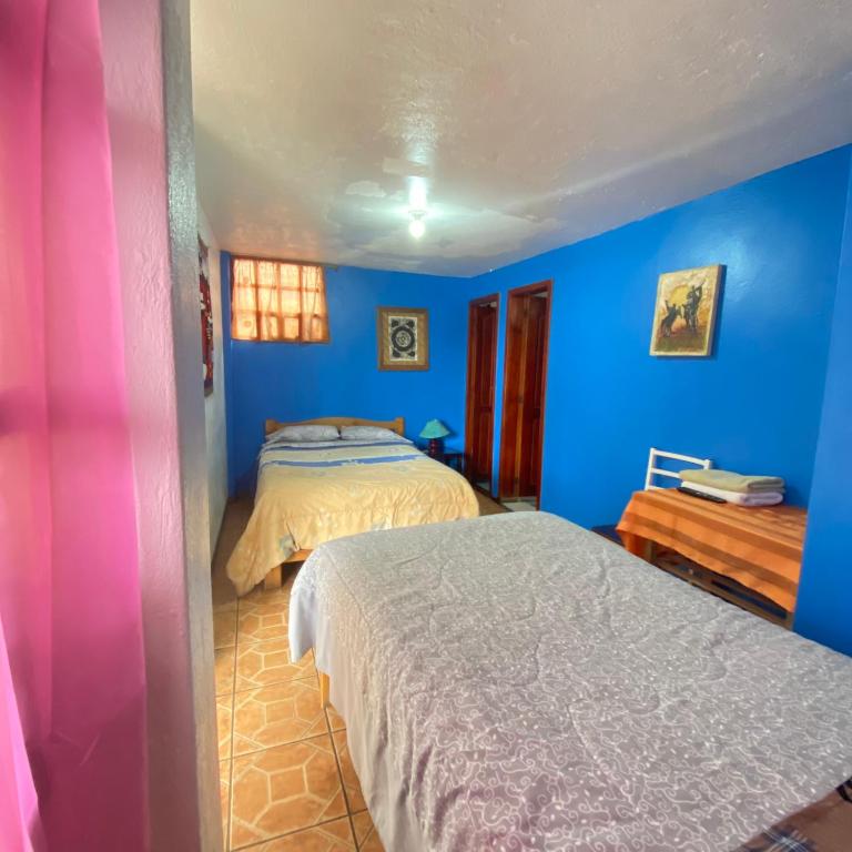 Postel nebo postele na pokoji v ubytování Hostal Chasqui