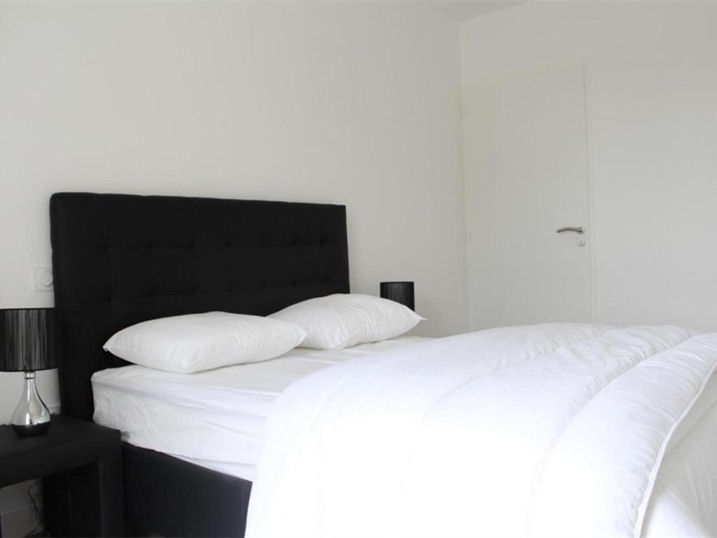 a white bed with two pillows on top of it at Appartement La Rochelle, 2 pièces, 4 personnes - FR-1-246-160 in La Rochelle