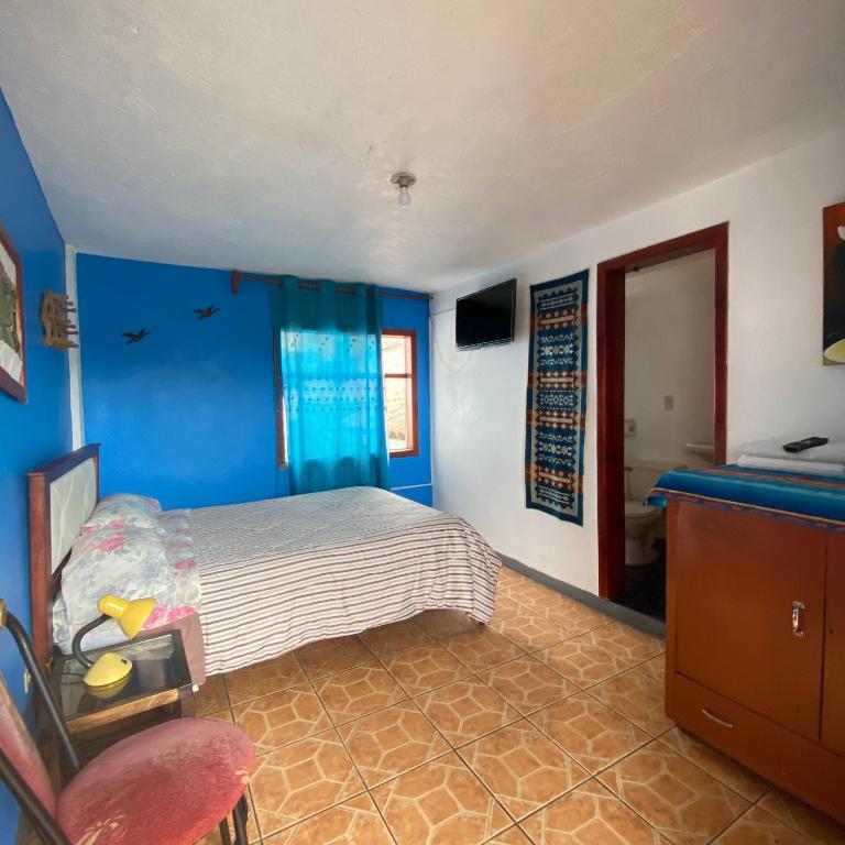 Postel nebo postele na pokoji v ubytování Hostal Chasqui
