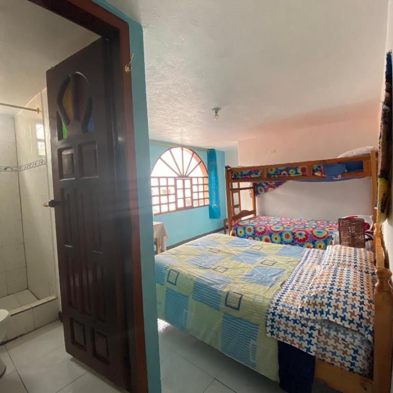 Postel nebo postele na pokoji v ubytování Hostal Chasqui
