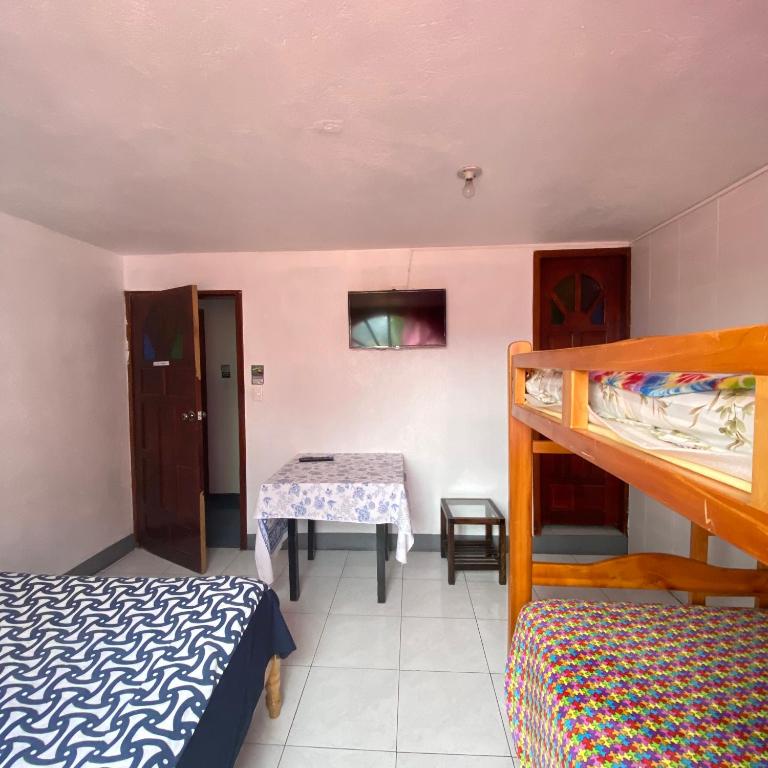 Postel nebo postele na pokoji v ubytování Hostal Chasqui