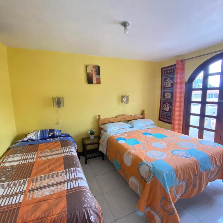 Postel nebo postele na pokoji v ubytování Hostal Chasqui