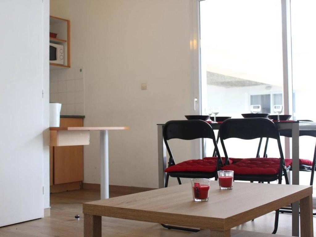 a table with two chairs and a table with two glasses on it at Appartement La Rochelle, 2 pièces, 4 personnes - FR-1-246-273 in La Rochelle