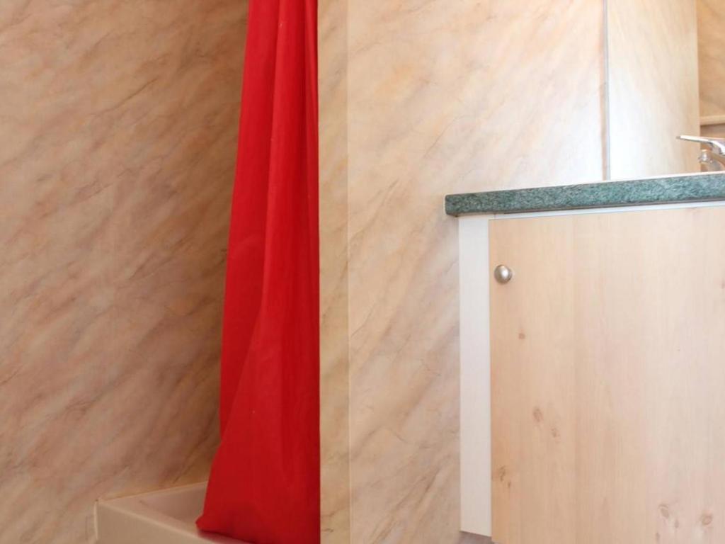 a red curtain next to a wooden wall at Appartement La Rochelle, 2 pièces, 4 personnes - FR-1-246-286 in La Rochelle