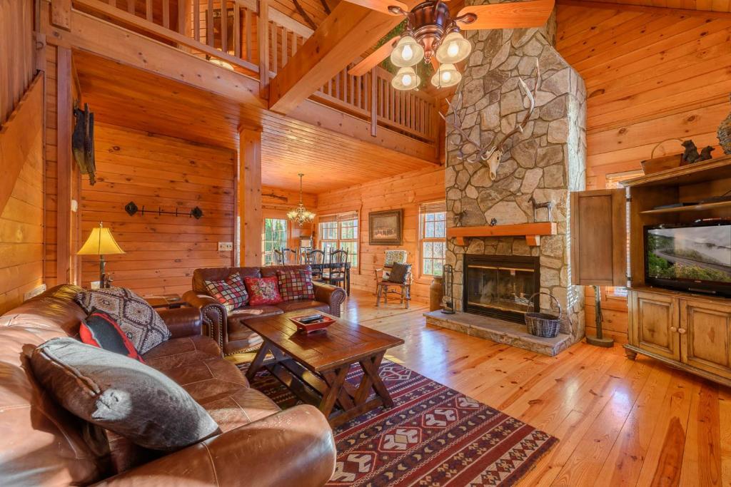a living room with a couch and a fireplace at 3 Bears Den in Boone