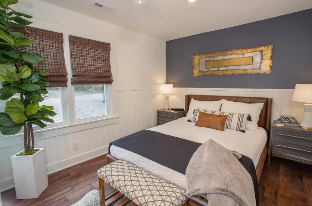 a bedroom with a bed and two windows at Cottage Fever in Blowing Rock