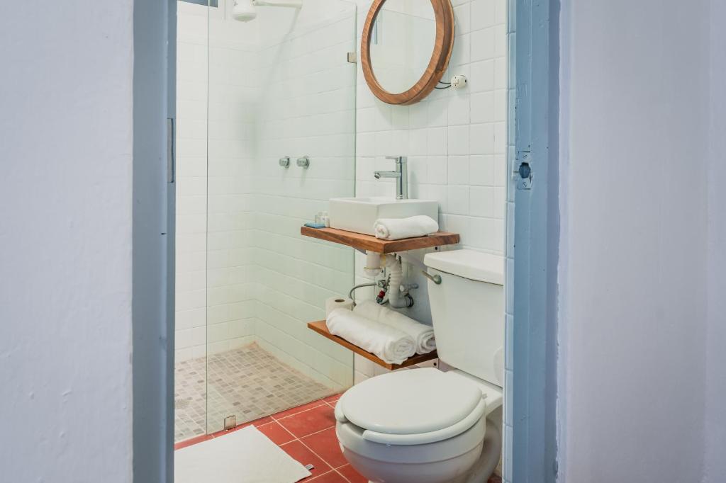 a bathroom with a toilet and a shower at Creta Hotel & Suites in Mazatlán